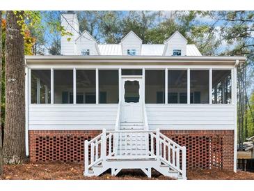 Charming screened porch with white railings and brick base, perfect for relaxing outdoors at 5500 Mccoy Nw Rd, Acworth, GA 30101