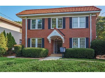 Charming brick home featuring a red tile roof, black shutters and mature landscaping at 824 Greenwood Ne Ave # 8, Atlanta, GA 30306
