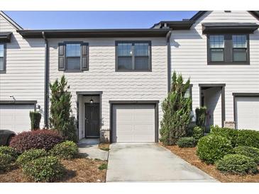 Charming townhome with a one-car garage and beautifully landscaped front yard at 6345 Mountain Home Se Way, Mableton, GA 30126