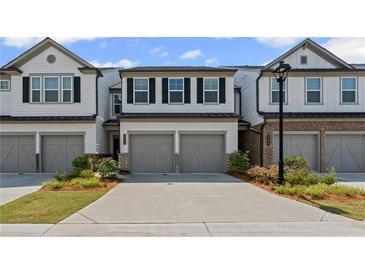 Charming townhome with two-car garage and well-manicured landscaping at 3560 Bexton Dr, Duluth, GA 30097