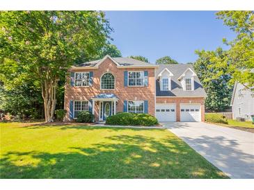 Charming two-story brick home with well-maintained lawn and a two-car garage at 2346 Hampton Park Dr, Buford, GA 30519
