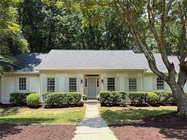 Charming single-story home with well-manicured front yard and classic architectural details at 1590 Sunnybrook Farm Road Rd, Atlanta, GA 30350