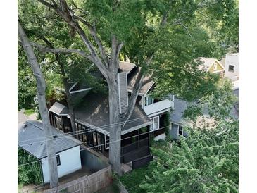 A lush, tree-filled canopy surrounds this charming home with a porch and balcony, offering privacy and a tranquil setting at 770 Barnett Street Northeast Ne St, Atlanta, GA 30306