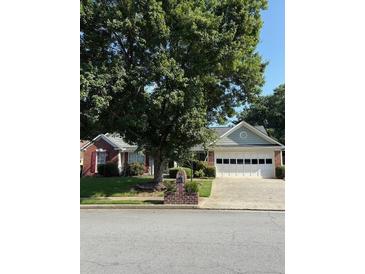 Charming single-story home with a two-car garage, brick mailbox, and mature trees in a quiet neighborhood at 1875 Conners Ct, Lawrenceville, GA 30044