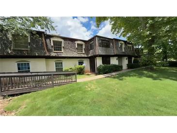 Charming townhome featuring a well-maintained lawn and inviting entrance, perfect for comfortable living at 50 Le Parc Fontaine, Lithonia, GA 30038