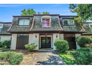 Charming condo featuring unique architectural details and a welcoming front entrance and mature landscaping at 50 Le Parc Fontaine, Lithonia, GA 30038
