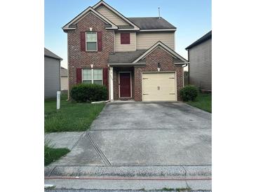 Two-story brick home with a attached one car garage and a well-manicured lawn at 5752 Little River Rd, Atlanta, GA 30349