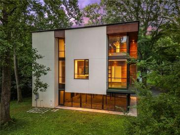 Modern home with large windows, wood accents, and lush greenery surrounding the property at 2105 Fairhaven Ne Cir, Atlanta, GA 30305