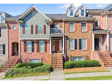 Attractive brick townhome featuring a well-maintained landscape and a charming exterior staircase at 2345 Gallard St, Lawrenceville, GA 30043