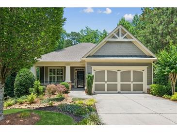 Charming single-story home with a well-manicured lawn, mature trees and a two car garage at 328 Shade Tree Cir, Woodstock, GA 30188