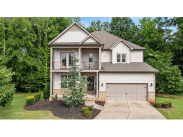 Charming two-story home features a welcoming front porch and a well-manicured lawn at 4814 Little Cove Ct, Auburn, GA 30011