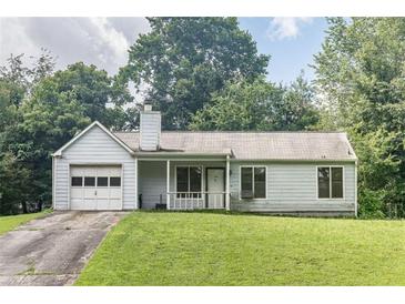 Classic one-story home with an attached garage and a well-maintained front lawn, creating a welcoming curb appeal at 504 Azalea Ct, Woodstock, GA 30188