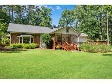 Expansive, well-manicured backyard with a charming deck, perfect for outdoor gatherings and relaxation at 435 Old Holly Rd, Milton, GA 30075