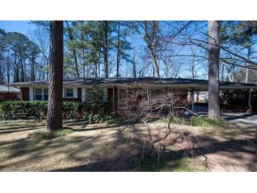 Charming single story home with mature landscaping, carport and red brick exterior at 1288 Skyview Sw Cir, Mableton, GA 30126