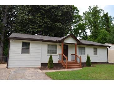 Charming white brick and siding home with a cozy front porch and well-maintained landscaping at 2349 Springdale Rd, Atlanta, GA 30315