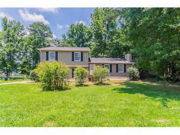 Charming two-story home with well-maintained lawn and mature trees at 2957 Temple Johnson Rd, Snellville, GA 30039