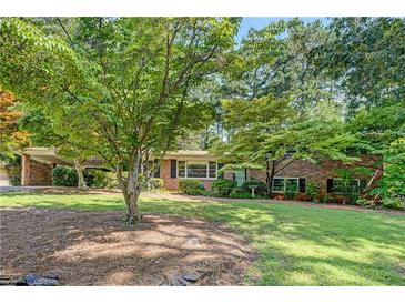 Charming brick home featuring lush landscaping and a spacious, well-maintained front yard at 3746 Gladney Dr, Atlanta, GA 30341