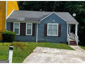 Charming single-story home featuring a well-maintained lawn and a private driveway at 6470 Bedford Ln, Lithonia, GA 30058