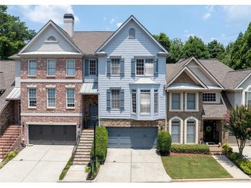 Charming townhome with a well-manicured front yard, neutral palette, and covered front porch at 196 Mystic Ct, Atlanta, GA 30342