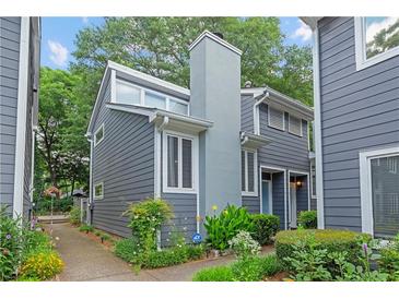 Charming gray two-story home with landscaped yard and inviting walkway leading to the entrance at 836 Saint Charles Ne Ave # I, Atlanta, GA 30306