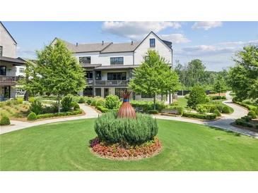 Beautifully landscaped front yard with walking paths and green spaces at this charming residence at 6930 Whitman Walk, Alpharetta, GA 30005