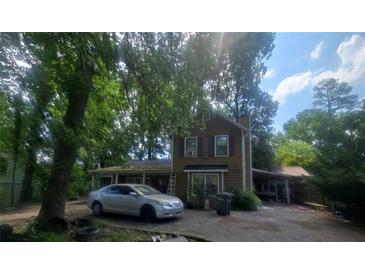 Two-story home with wood siding and a car parked out front at 1383 Natchez Sw Trce, Marietta, GA 30008