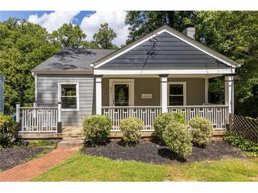 Charming home with a welcoming front porch and manicured landscaping at 217 Rockyford Ne Rd, Atlanta, GA 30317