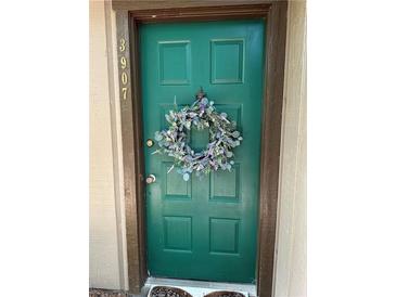 Inviting green front door with a floral wreath, showcasing curb appeal at this cozy home entrance at 3907 Cedar Cir, Tucker, GA 30084