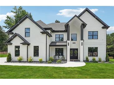 Stunning two-story home with black-framed windows and doors, set on a lush green lawn at 4292 Sardis Church Rd, Buford, GA 30519