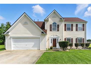 Charming two-story home with an attached two-car garage, manicured lawn, and classic shuttered windows at 150 Crestworth Xing, Powder Springs, GA 30127