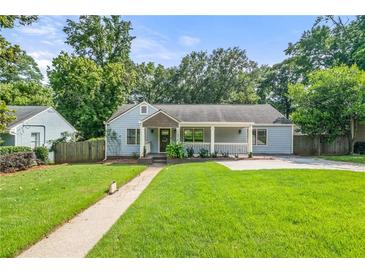 Charming single-story home with a well-manicured lawn and inviting front porch at 1895 Flat Shoals Se Rd, Atlanta, GA 30316