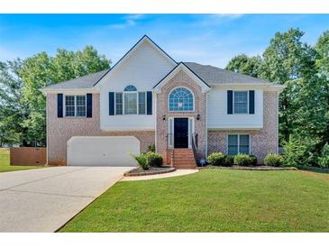 Charming two-story brick home with a well-maintained front lawn, two-car garage, and beautiful landscaping at 1331 Red Hill Rd, Marietta, GA 30008