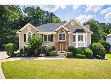 Charming traditional home with well-manicured lawn and lush landscaping providing great curb appeal at 1811 Ascot Nw Cv, Acworth, GA 30102
