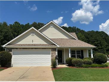 Charming single-story home featuring a two-car garage, well-maintained lawn, and traditional architectural details at 345 Annslee Circle Cir, Loganville, GA 30052