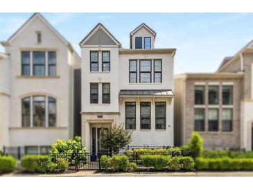 Charming, modern, three-story white brick home with black-trimmed windows, black metal fence, and verdant landscaping at 506 Broadview Ne Pl, Atlanta, GA 30324