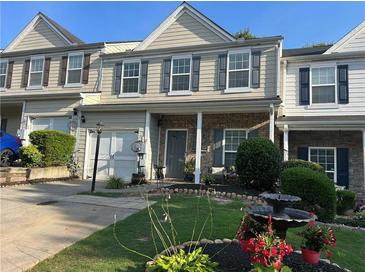 Charming townhome with a well-manicured lawn and inviting curb appeal at 127 Spring Way Sq, Canton, GA 30114