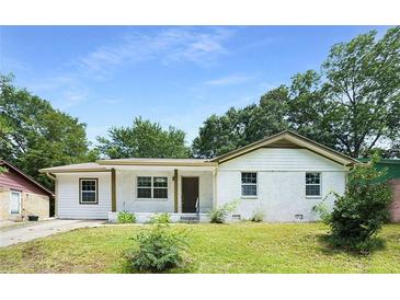 Charming single-story home featuring a brick facade and a well-maintained lawn at 2005 Simmons Ave, Atlanta, GA 30337