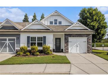 Charming townhome featuring stone accents, a well-manicured lawn, and a welcoming front entrance at 111 Point View Dr, Canton, GA 30114