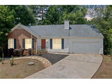 Charming one-story home with brick and vinyl siding, a well-manicured lawn, and a concrete driveway at 3997 Paloverde Nw Dr, Kennesaw, GA 30144