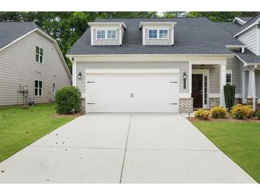 Charming home featuring a two-car garage with a concrete driveway and well-maintained landscaping at 4554 Grenadine Cir, Acworth, GA 30101