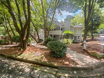 Two-story condo with balcony surrounded by mature trees and landscaping at 501 Vicksburg Pl, Atlanta, GA 30350
