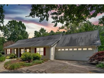 Charming home featuring a well-manicured front yard and a convenient two-car garage at 3122 Harmony Rd, Temple, GA 30179