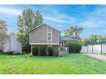Charming two-story home featuring mature trees, inviting front porch, and a lush green lawn at 8670 Brandon Hill Ln, Jonesboro, GA 30238