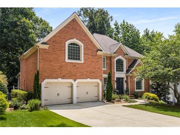 Beautiful brick home featuring a two-car garage and well-maintained landscaping, offering classic elegance at 290 Edwardton Ct, Roswell, GA 30076