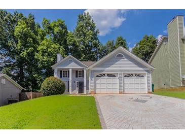 Charming two-story home featuring a two-car garage, well-maintained lawn, and a classic facade at 4968 Windsor Downs Ln, Decatur, GA 30035