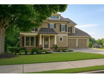 Charming two-story home with a well-manicured lawn and a two-car garage at 730 Midway Ave, Canton, GA 30114