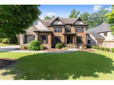 Charming two-story brick home with a well-manicured lawn and stone accents at 2539 Sagebrush Trl, Buford, GA 30519