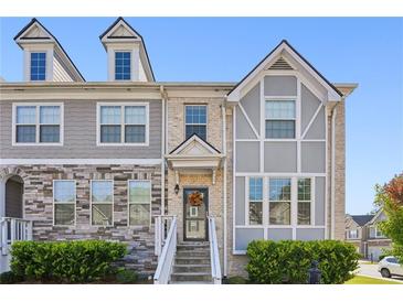 Charming townhome featuring a beautifully designed brick and siding exterior with a welcoming entrance and manicured landscaping at 5534 Radford Loop, Fairburn, GA 30213