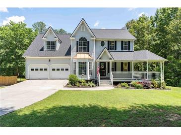 Charming two-story home with a well-manicured lawn, covered porch, and a two-car garage at 20 Scarlett Oak Ne Dr, Cartersville, GA 30121