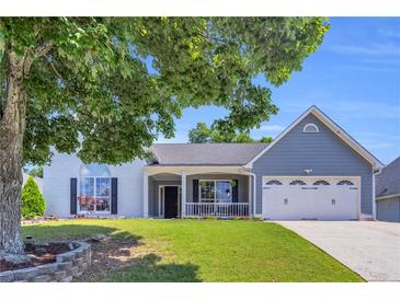 Charming home with a large, manicured front yard and a welcoming porch at 499 Running Doe Ct, Suwanee, GA 30024